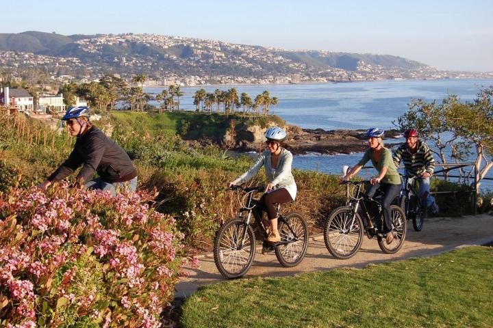 a group of people riding on the back of a bicycle