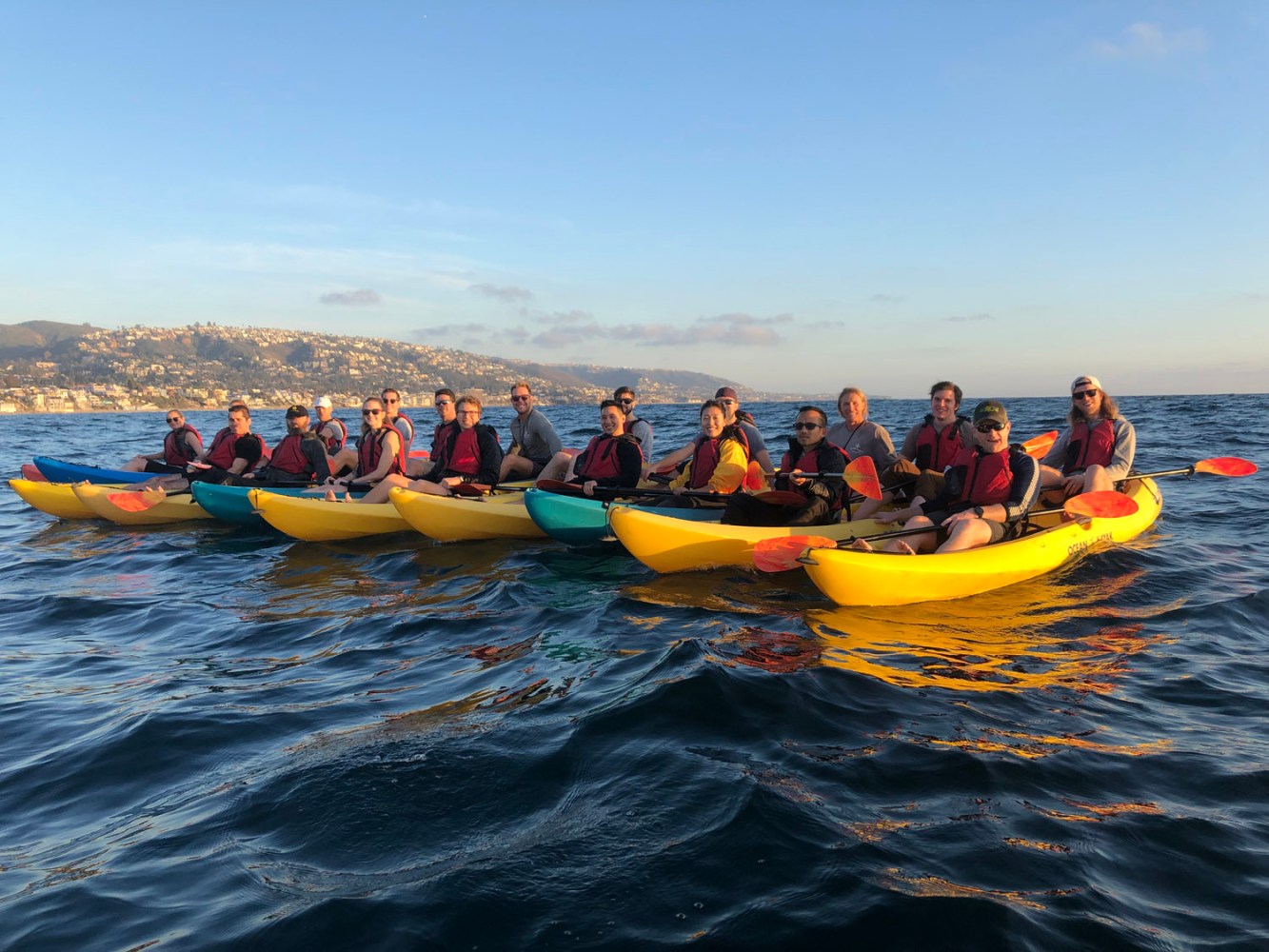 a group of people in kayaks on ocean