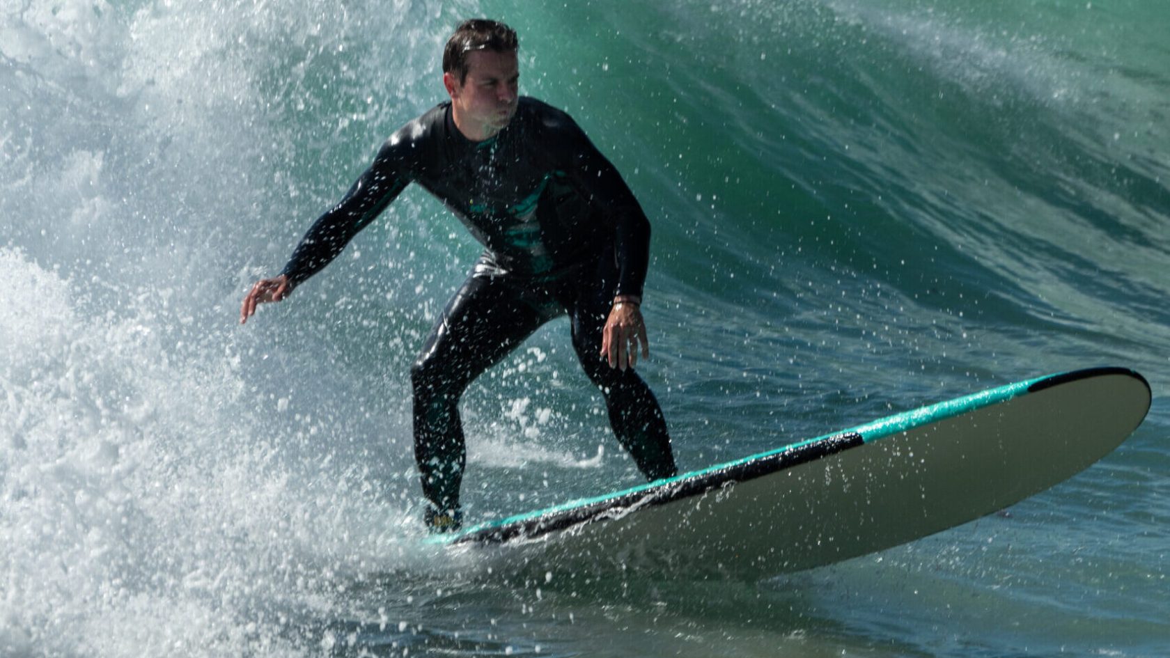 a person riding a wave on a surfboard in the water