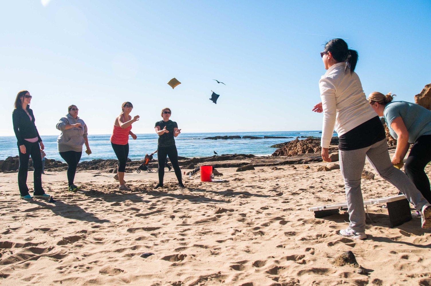 a group of people playing on a beach