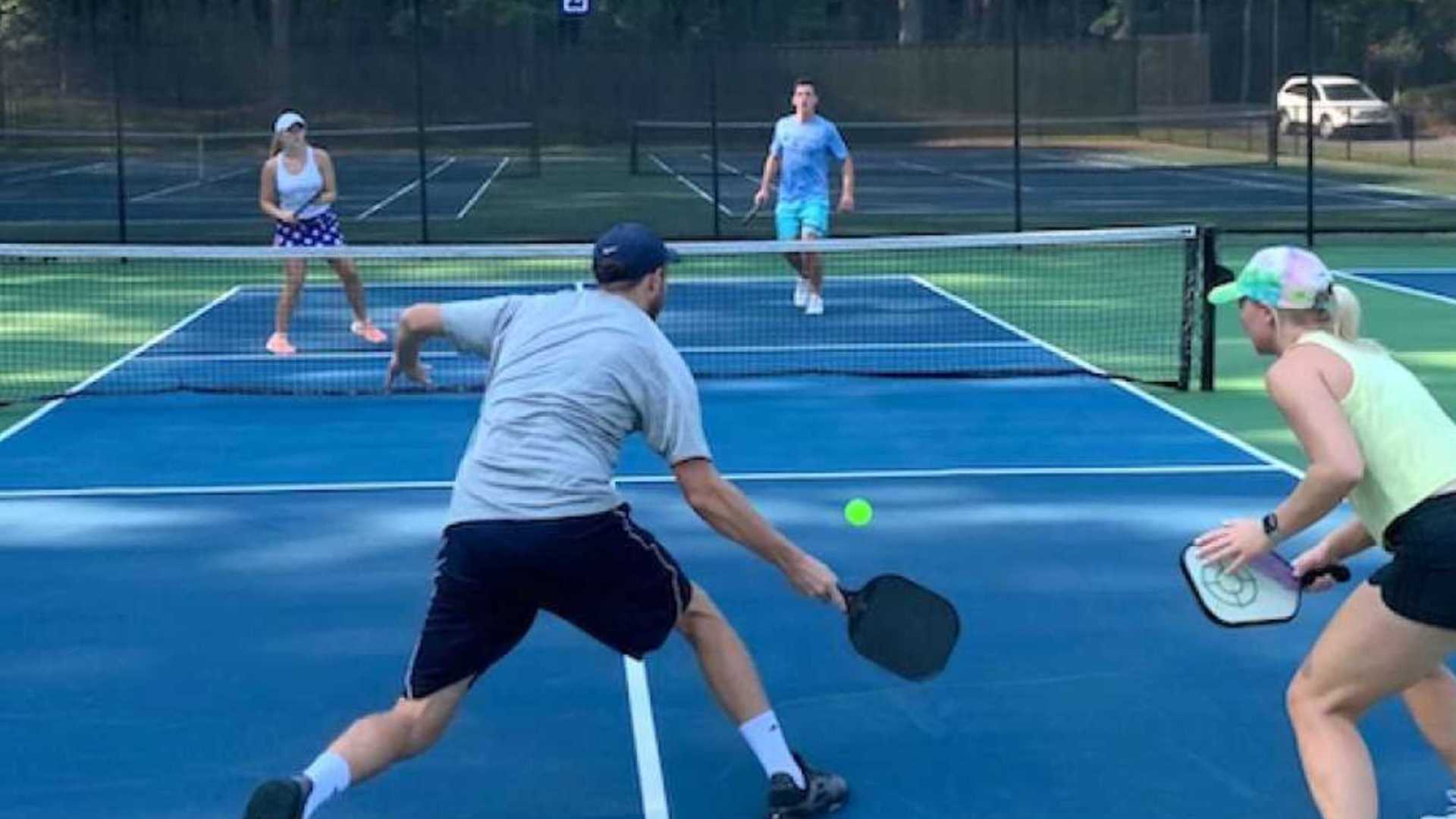 a person hitting a ball with a racket on a court